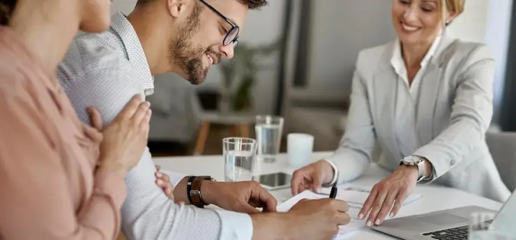 happy-man-his-wife-having-meeting-with-financial-advisor-signing-agreement-office_637285-6121.webp